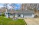 Charming single-story home with attached garage, neat landscaping and cozy front yard at 3232 Beech Dr, Columbus, IN 47203