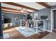 Spacious home office with hardwood floors, exposed ceiling beams, ceiling fan, and built-in shelving is perfect for remote work at 3232 Beech Dr, Columbus, IN 47203