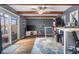 Home office featuring a ceiling fan, exposed beams, and glass doors leading to an outdoor space for added convenience at 3232 Beech Dr, Columbus, IN 47203