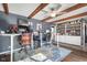 Bright home office with hardwood floors, exposed ceiling beams, ceiling fan, and built-in shelving is perfect for remote work at 3232 Beech Dr, Columbus, IN 47203