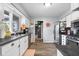 A kitchen with stainless steel appliances, white cabinets, and wood flooring at 3232 Beech Dr, Columbus, IN 47203
