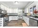Traditional kitchen with stainless steel appliances, white cabinets, and a view to dining room at 3232 Beech Dr, Columbus, IN 47203