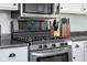 A kitchen with stainless steel oven, microwave and gas stove with wooden knife blocks on the countertop at 3232 Beech Dr, Columbus, IN 47203