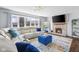Bright living room with fireplace, large windows, comfortable seating, and modern accents at 3232 Beech Dr, Columbus, IN 47203
