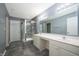 Bathroom features a double sink vanity, walk-in shower with glass door, and contemporary fixtures at 3328 Stoddard Pl, Indianapolis, IN 46217