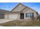 Charming single Gathering home features a three car garage, brick accents, and neutral siding, and a well-manicured lawn at 3328 Stoddard Pl, Indianapolis, IN 46217