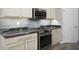 Elegant kitchen features stainless steel appliances, granite countertops, and cream-colored cabinets at 3328 Stoddard Pl, Indianapolis, IN 46217