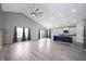 Open-concept living area with cathedral ceilings, wood-look floors, recessed lights, and a ceiling fan at 3328 Stoddard Pl, Indianapolis, IN 46217
