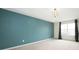Spacious main bedroom features a tray ceiling, modern chandelier, large picture window, and light carpet at 3328 Stoddard Pl, Indianapolis, IN 46217
