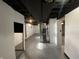 A finished basement with painted walls and ceiling, featuring an open layout and concrete floors at 3516 N Sherman Dr, Indianapolis, IN 46218