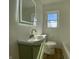 Sunlit bathroom with a contemporary vanity, sleek fixtures and white tiled walls at 3516 N Sherman Dr, Indianapolis, IN 46218