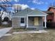 Charming home with a stone facade, bright yellow front door, and inviting covered porch at 3516 N Sherman Dr, Indianapolis, IN 46218