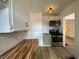 Well-lit kitchen with stainless steel appliances and green cabinetry at 3516 N Sherman Dr, Indianapolis, IN 46218
