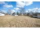 Large backyard with a lawn, trees and bordering fences. House addition visible on the right at 3626 St. Charles St, Anderson, IN 46013