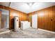 Utility basement with wood panelling, water heater, washer and dryer and vinyl floor tiles at 3626 St. Charles St, Anderson, IN 46013
