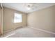 Neutral bedroom with neutral carpet, light tan walls, window and white ceiling fan and baseboard at 3626 St. Charles St, Anderson, IN 46013