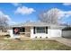 Charming ranch home with white siding, black shutters, and an inviting front porch at 3626 St. Charles St, Anderson, IN 46013