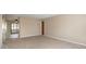 Neutral living space with carpet, light walls, and view into enclosed sunroom at 3626 St. Charles St, Anderson, IN 46013