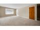 Inviting living area with neutral carpet and light-filled window at 3626 St. Charles St, Anderson, IN 46013