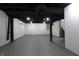 Unfinished basement showcasing the painted brick walls, dark ceiling beams, and concrete floor at 3645 N Delaware St, Indianapolis, IN 46205