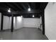 Large basement space with painted brick walls, dark ceiling beams, and concrete flooring at 3645 N Delaware St, Indianapolis, IN 46205