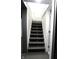 Basement staircase with white walls and finished with gray painted steps at 3645 N Delaware St, Indianapolis, IN 46205