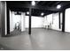 Open basement view with painted brick walls, dark ceiling beams, bathroom and concrete floor at 3645 N Delaware St, Indianapolis, IN 46205