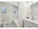Cozy bathroom with white vanity, tub, and marble accents at 3645 N Delaware St, Indianapolis, IN 46205
