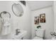 Well-lit bathroom with modern fixtures, unique sink, and stylish decor with grey accents at 3645 N Delaware St, Indianapolis, IN 46205