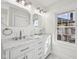 Bright bathroom featuring a double sink vanity with marble countertop and octagon mirrors at 3645 N Delaware St, Indianapolis, IN 46205
