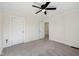 Clean bedroom with neutral carpet, ceiling fan, and white doors at 3645 N Delaware St, Indianapolis, IN 46205