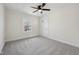 Spacious bedroom with neutral carpet, ceiling fan, and natural light at 3645 N Delaware St, Indianapolis, IN 46205