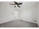 Bright, carpeted bedroom with a ceiling fan and an open doorway to another room at 3645 N Delaware St, Indianapolis, IN 46205