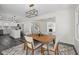 Bright dining room with modern light fixture, table for four, and open floor plan with gray vinyl floors at 3645 N Delaware St, Indianapolis, IN 46205