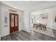 Welcoming entryway featuring a beautiful wooden door, luxury vinyl floors, and an adjacent dining area at 3645 N Delaware St, Indianapolis, IN 46205