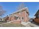 Beautiful exterior elevation of this brick home with a manicured lawn, bright windows, and paved driveway at 3645 N Delaware St, Indianapolis, IN 46205