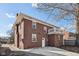 Brick two-story home with a rear balcony and concrete patio at 3645 N Delaware St, Indianapolis, IN 46205
