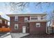 Rear exterior of the brick home, showcasing the outdoor area and second-story porch at 3645 N Delaware St, Indianapolis, IN 46205