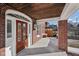 Inviting front porch with a decorative wood door, brick columns, and a clean, modern aesthetic at 3645 N Delaware St, Indianapolis, IN 46205