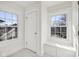 Hallway with white molding, built in bench, and natural light from two windows at 3645 N Delaware St, Indianapolis, IN 46205