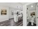 Modern kitchen featuring white cabinets, stainless steel appliances, and adjacent powder room at 3645 N Delaware St, Indianapolis, IN 46205