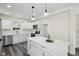 Modern kitchen featuring white cabinets, stainless steel appliances, and a large center island at 3645 N Delaware St, Indianapolis, IN 46205