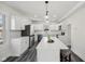 Modern kitchen featuring white cabinets, stainless steel appliances, and a large center island with bar seating at 3645 N Delaware St, Indianapolis, IN 46205