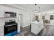 Bright modern kitchen featuring white cabinets, stainless steel appliances, and a large center island at 3645 N Delaware St, Indianapolis, IN 46205
