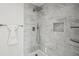 Stylish shower with marble tile surround, rainfall shower head, and recessed shelf at 3645 N Delaware St, Indianapolis, IN 46205
