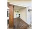 Inviting entryway showcasing a wooden porch, blue door, modern lighting, and brick accents at 3703 Church Dr, Anderson, IN 46013