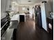 Bright open kitchen boasts black appliances, white cabinets, and dark hardwood flooring at 3703 Church Dr, Anderson, IN 46013