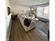 Bright living room featuring a large sectional, modern flooring, and plenty of natural light at 3703 Church Dr, Anderson, IN 46013
