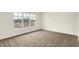 A bright bedroom with a large window overlooking the neighborhood at 3917 Wren Dr, Brownsburg, IN 46112