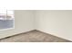 A neutral bedroom featuring tan carpet with a window at 3917 Wren Dr, Brownsburg, IN 46112